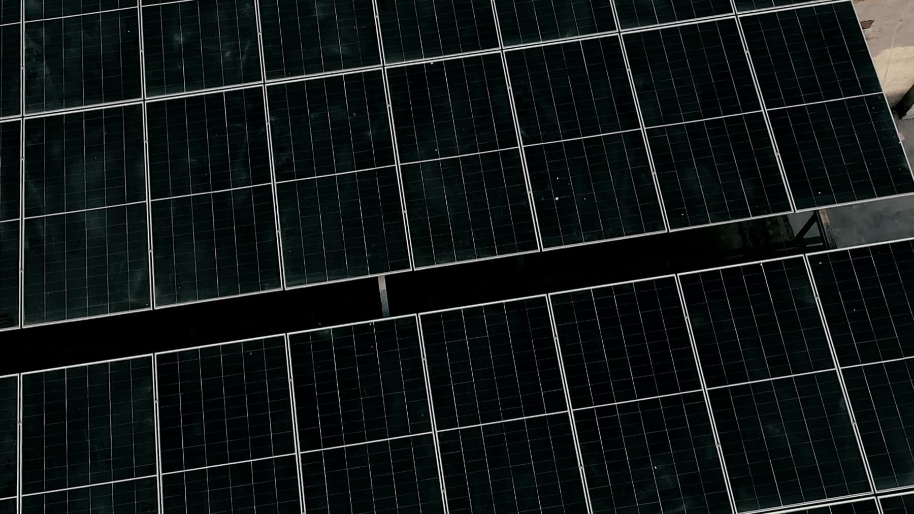 Top-down aerial view of a dense commercial solar panel array